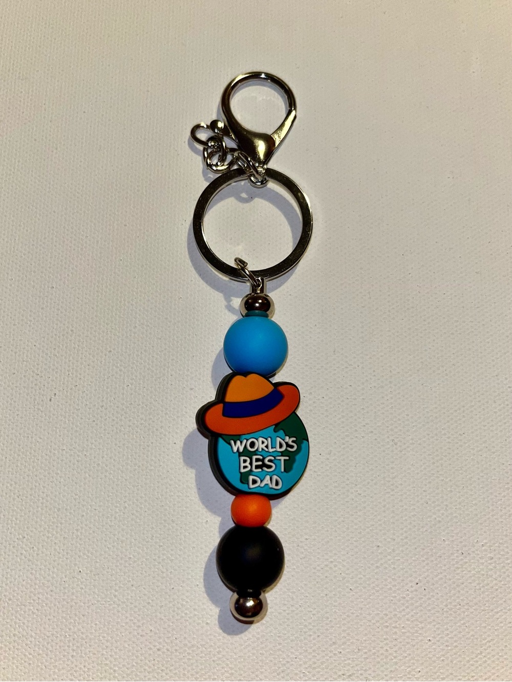 ‘World's Best Dad’ Globe w/Hat Charm Keychain in Blue, Orange & Black